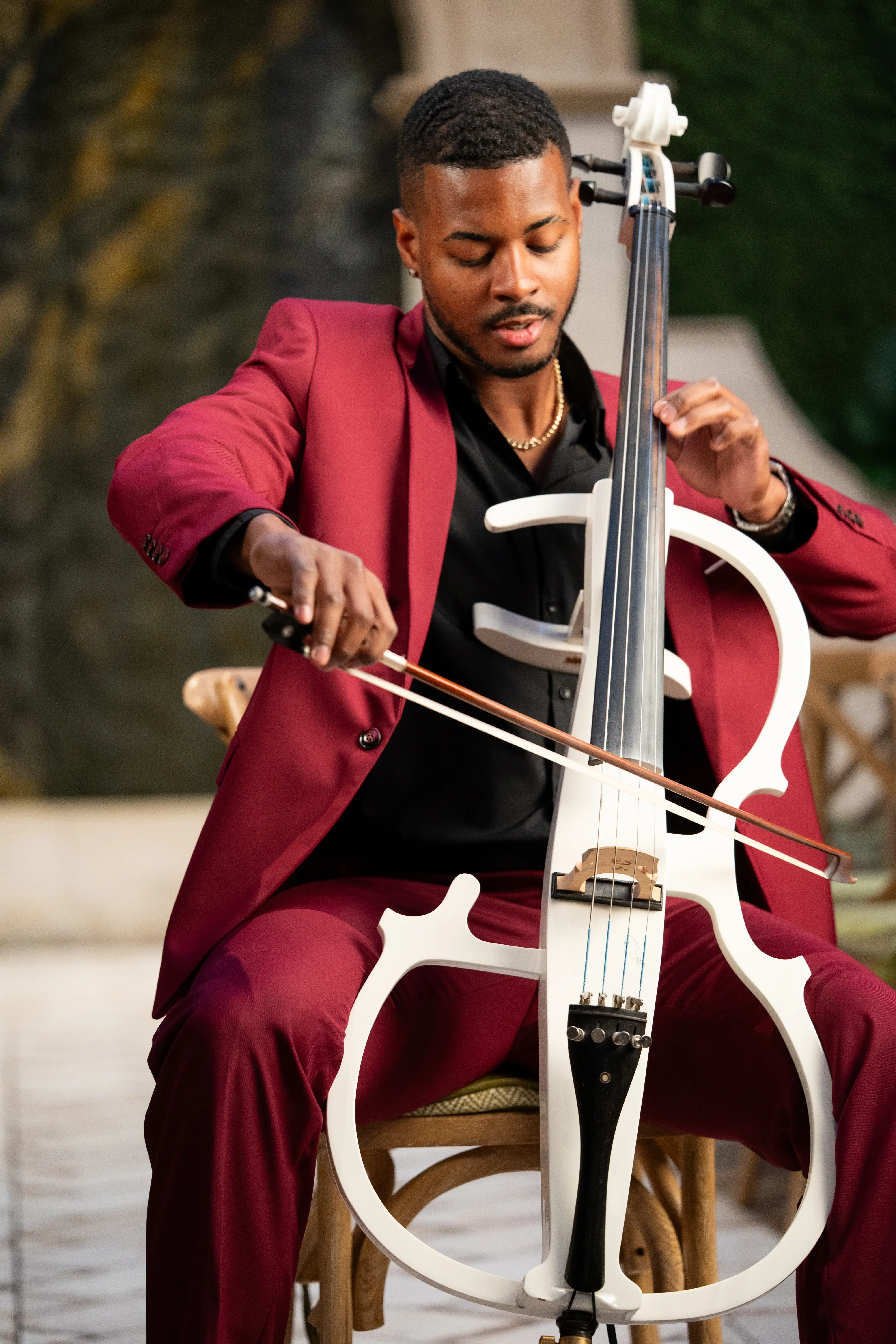 Dayron Fernandez playing cello at a wedding