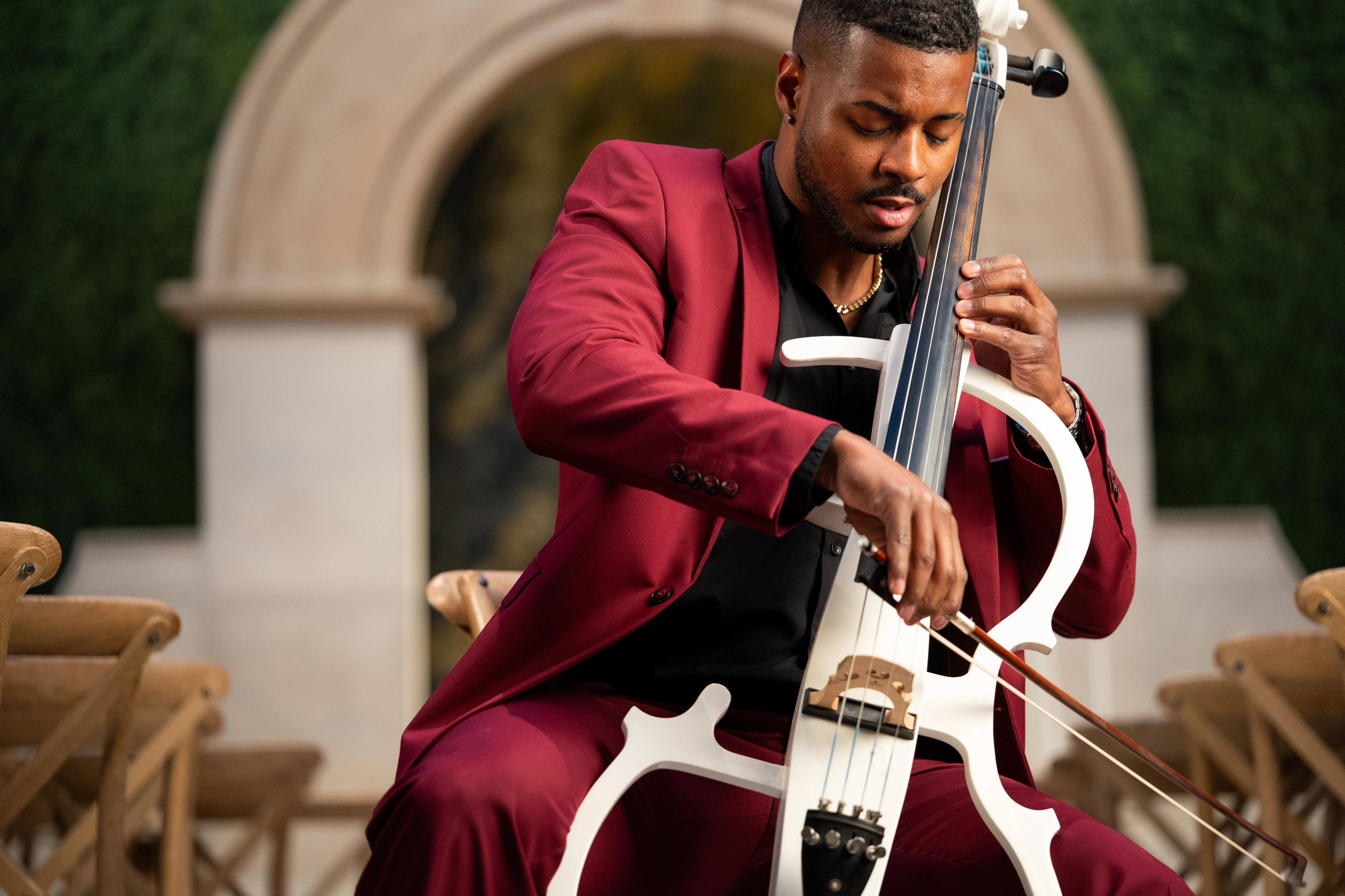 The Cello Guy bowing his cello beside the ceremony seating
