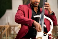 Close-up of The Cello Guy playing his white electric cello