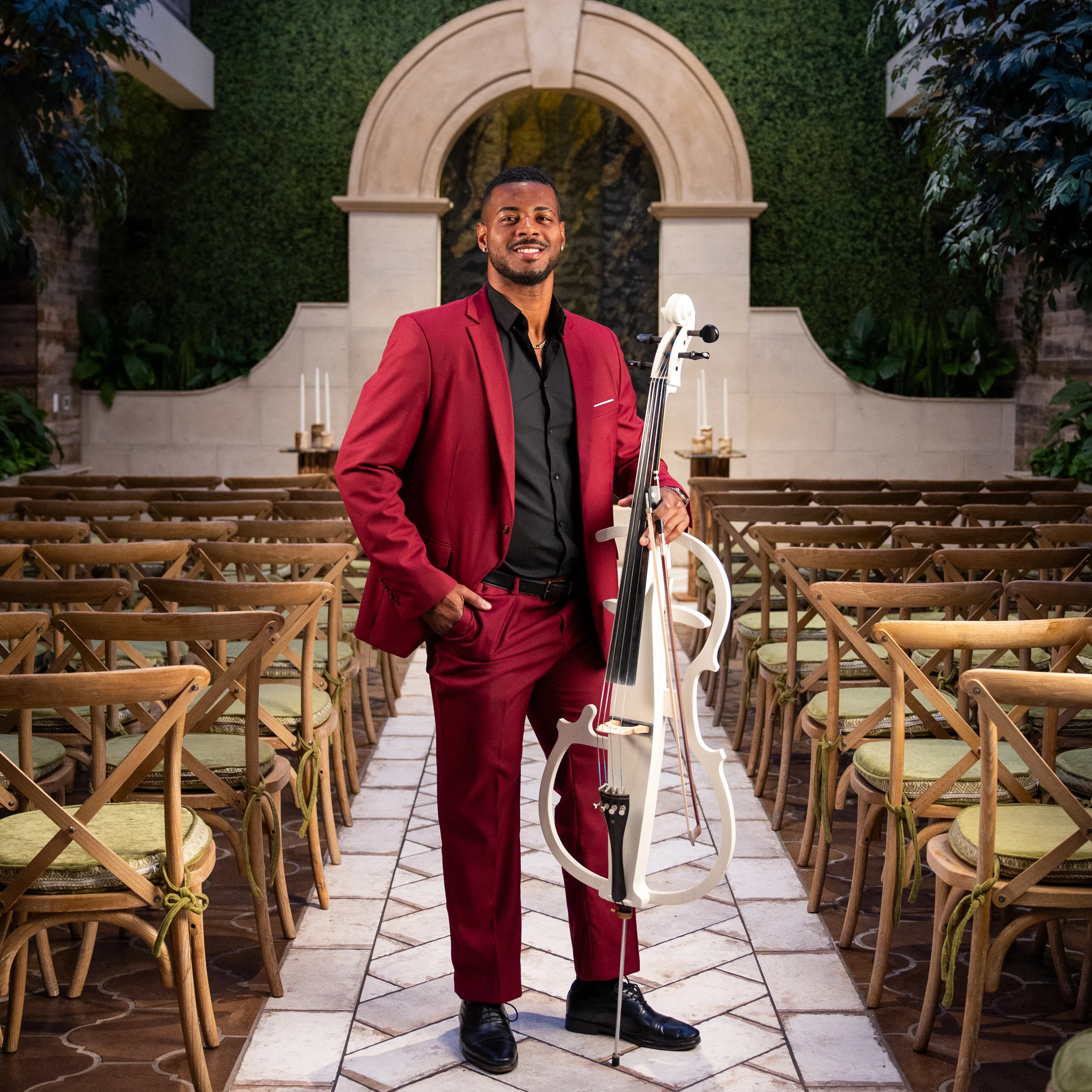 The Cello Guy standing with his cello in the wedding aisle