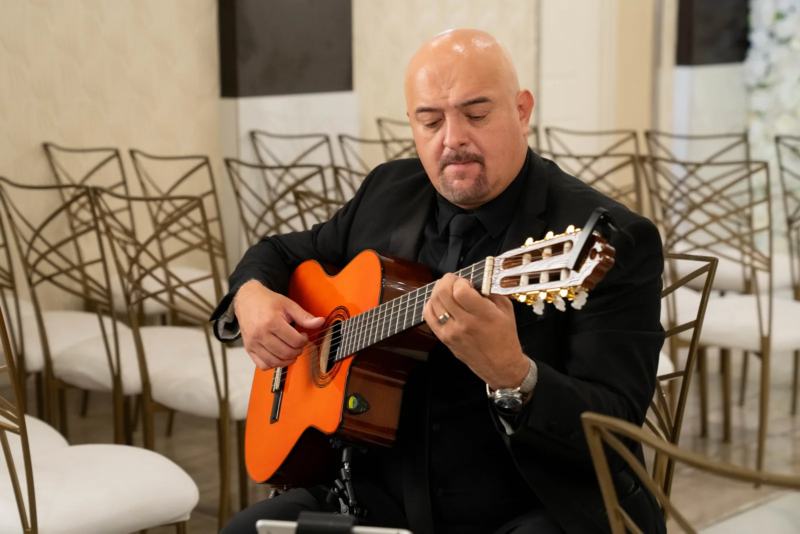 Close-up of Hans absorbed in playing his guitar, eyes closed